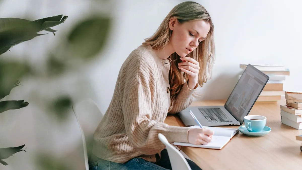 Budgeting in a notebook to raise a credit score in Canada