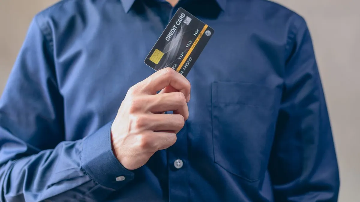Man holding a secured credit card to build credit in Canada