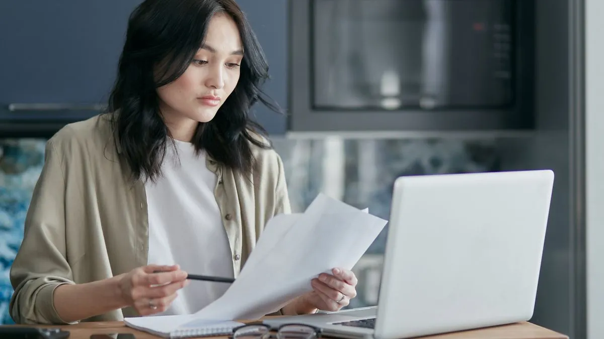Woman reviewing her credit report on a laptop in Canada