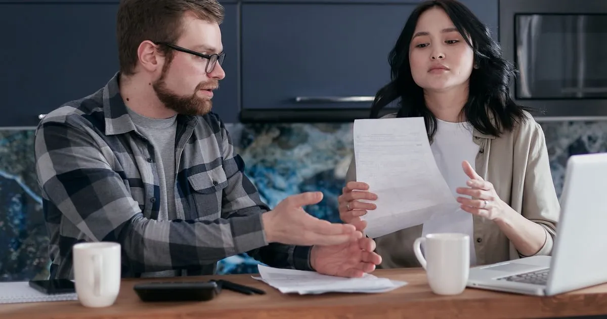 Couple comparing proposal vs bankruptcy options at their kitchen table