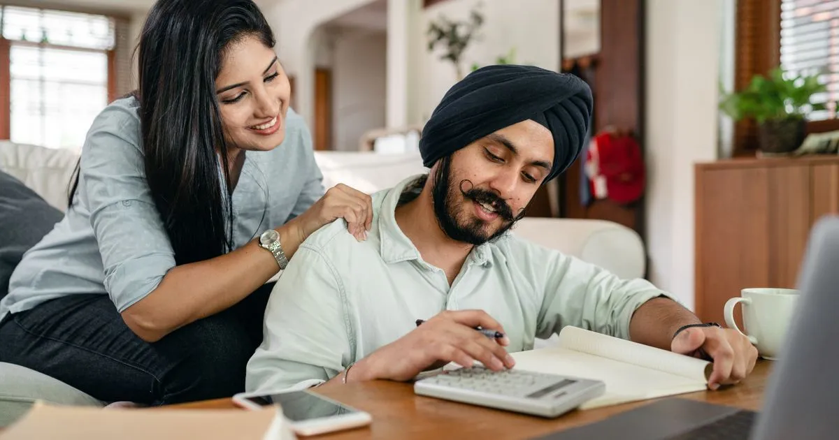 Couple working through their fix my credit plan at home in Canada