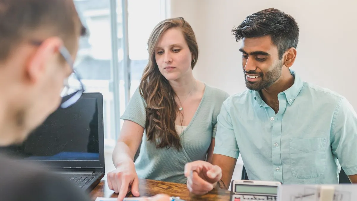 Couple getting help from a credit specialist to raise their credit score