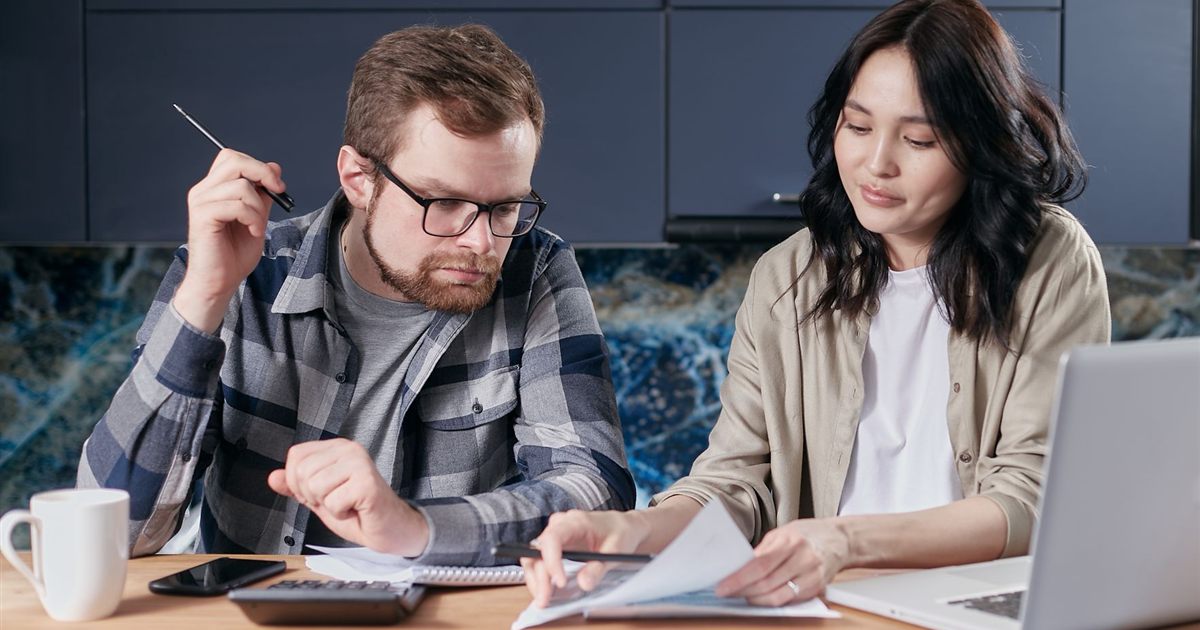 Couple reviewing a debt management plan to protect their credit in Canada