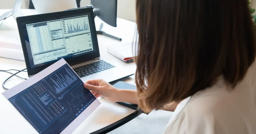 Person reviewing financial charts to raise your credit score from 500 to 700 in Canada