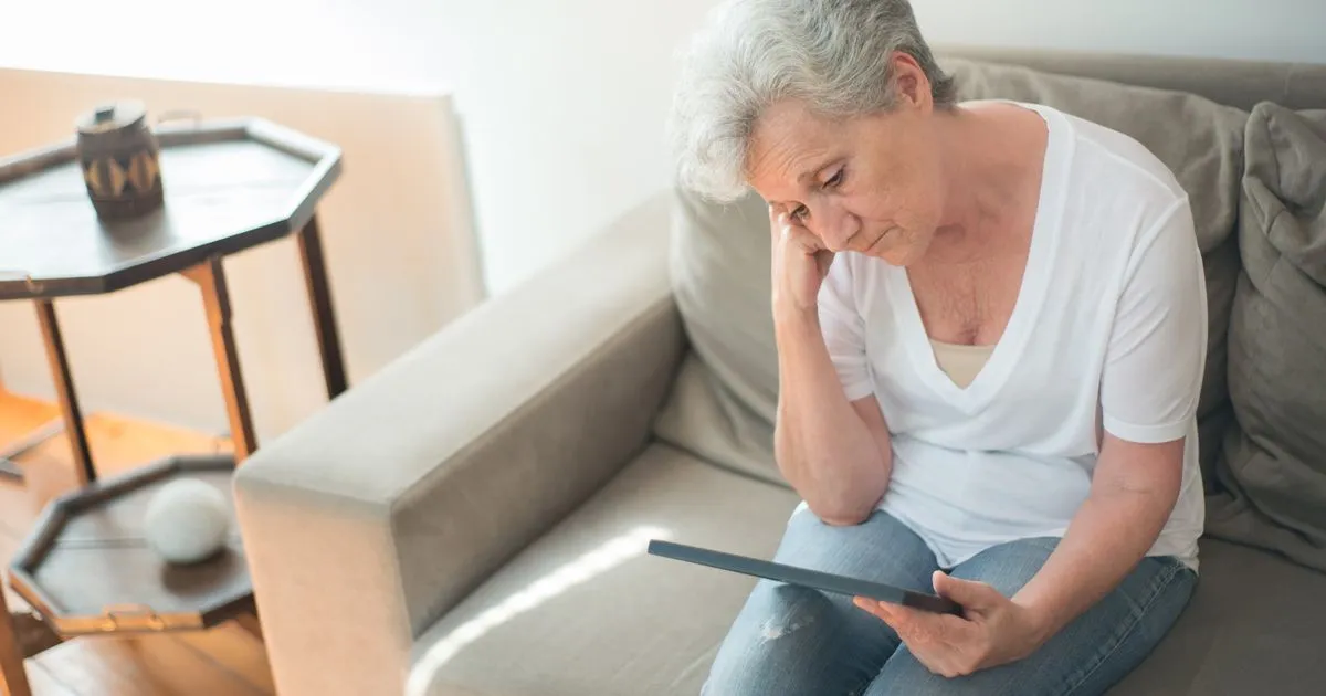 Reviewing debt relief options on a tablet at home