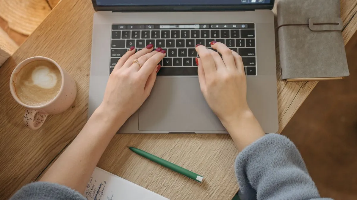 Tracking credit score progress on a laptop at home in Canada