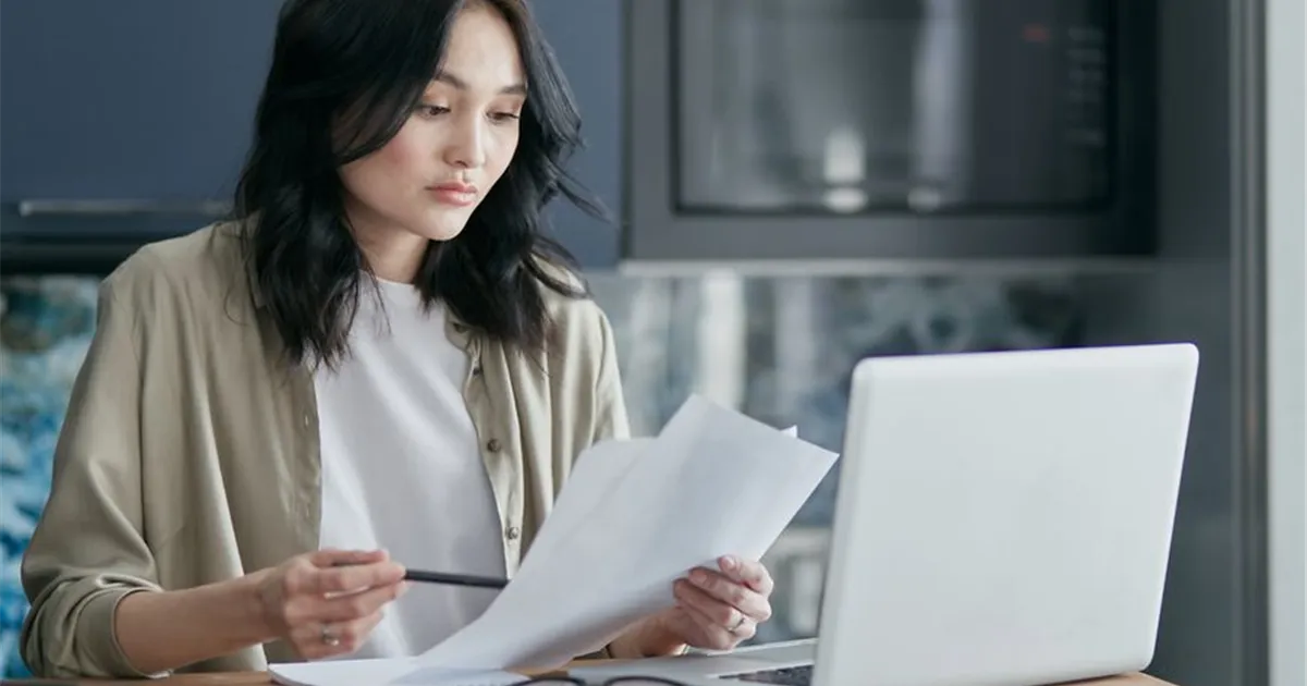 Woman reviewing her credit report to prepare a TransUnion dispute in Canada