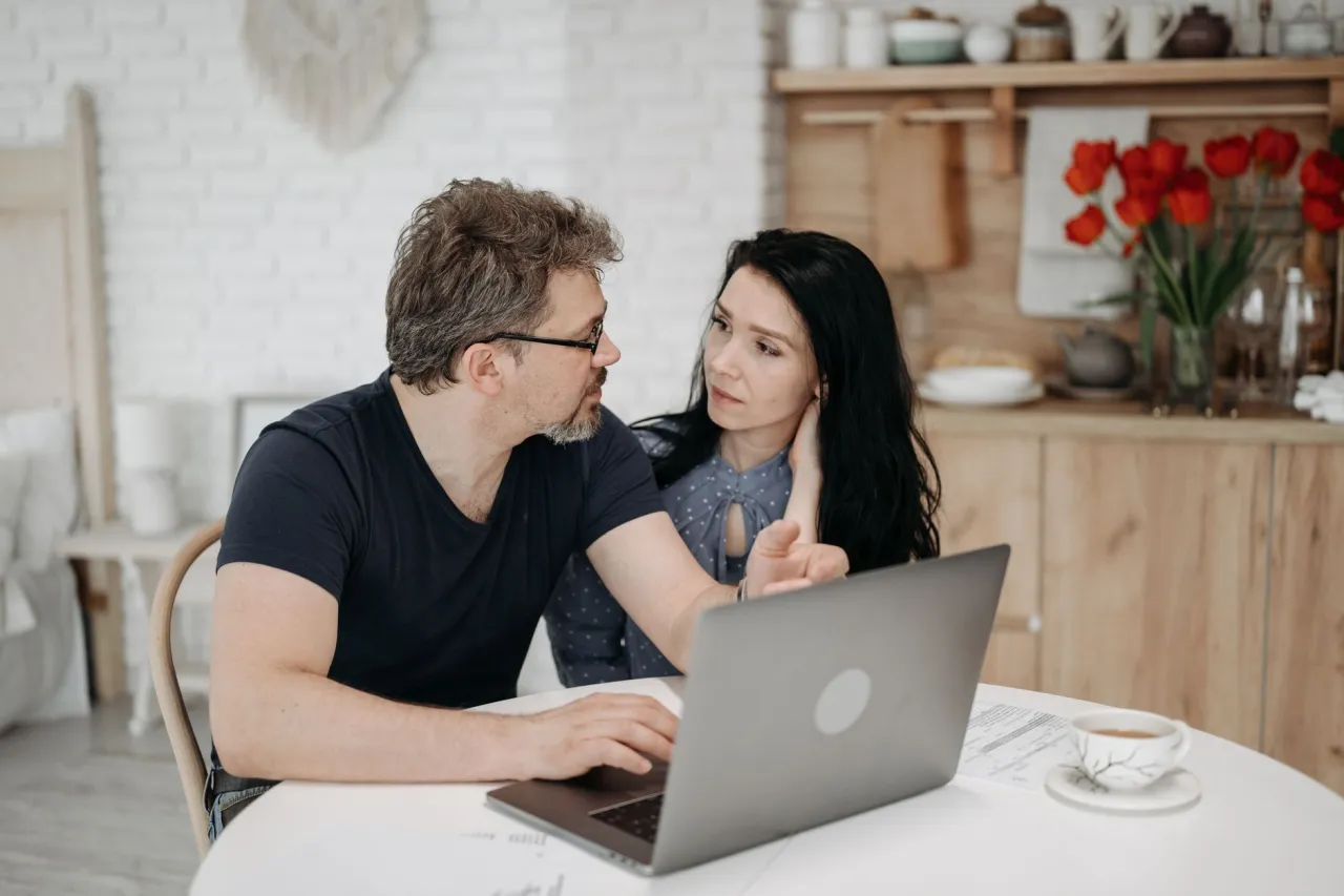 Mid-career couple reviewing their credit picture at home