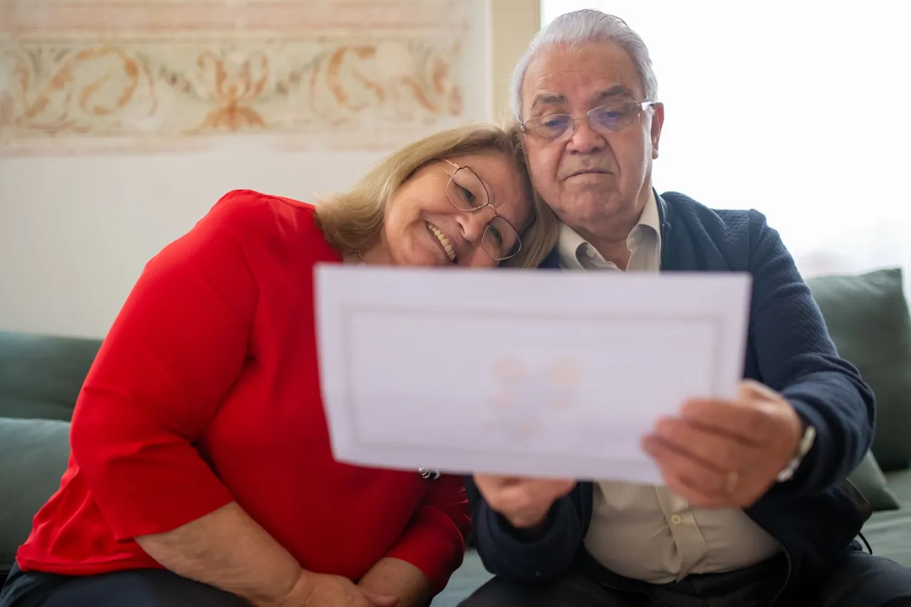 Senior couple reviewing estate and debt papers together