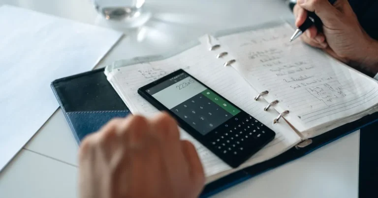 Working out how to build credit without a credit card using a notebook and phone calculator