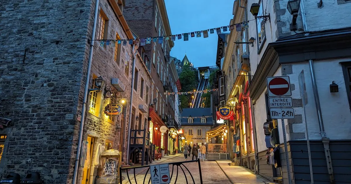 Debt consolidation Quebec: an illuminated street in Old Quebec City at dusk