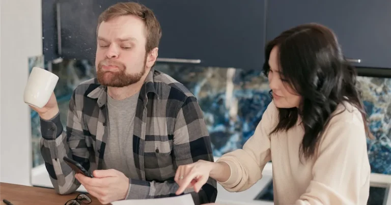 Couple reviewing bills while considering an orderly payment of debts program