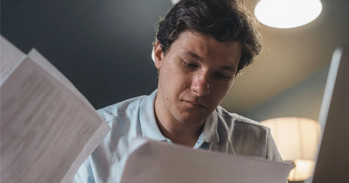Man reading the terms of his consumer proposal after a change in his income