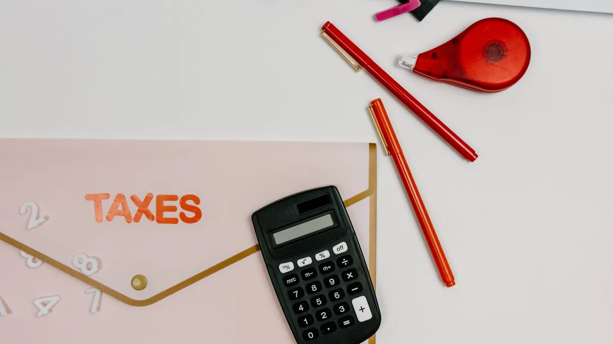 Tax folder and calculator on a desk, laid out before a CRA debt forgiveness request is filed