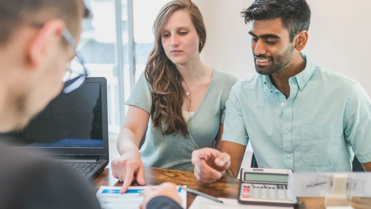 Couple going through their credit report with a credit counsellor as part of a credit repair plan