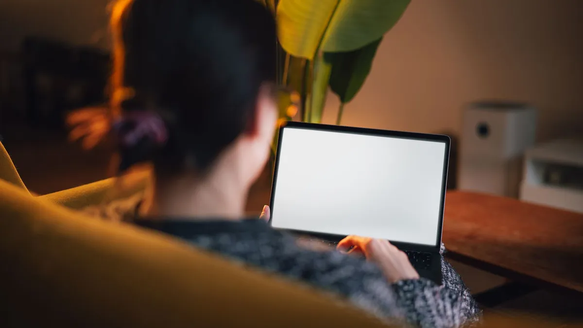 Woman filing a credit repair dispute online from her living room laptop