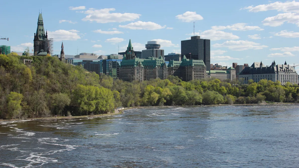 Parliament Hill and the Ottawa River, where the federal privacy and criminal laws behind credit repair in Canada are made