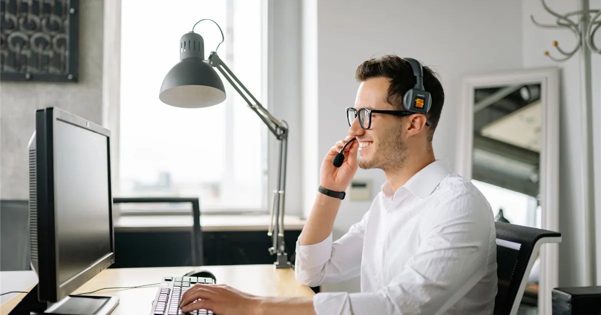 Lender credit reporting agent on a headset taking a goodwill request to remove late payments